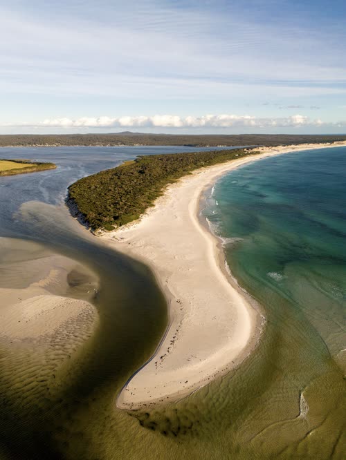 Aerial view of a tidal lagoon and white sand spit on the Tasmanian coast