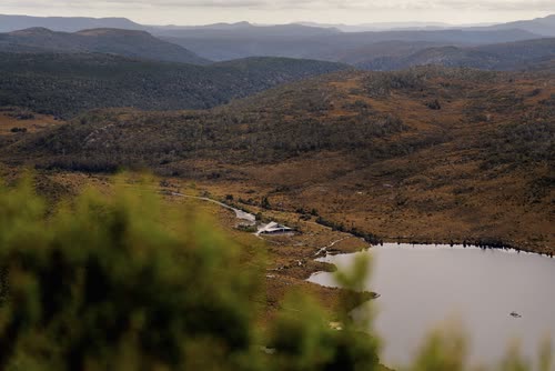Aerial view of a tarn among alpine heath below the ranges, Tasmania