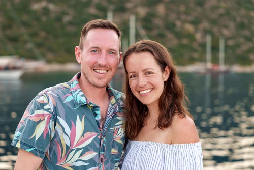 A couple photographed on deck against a Turkish bay