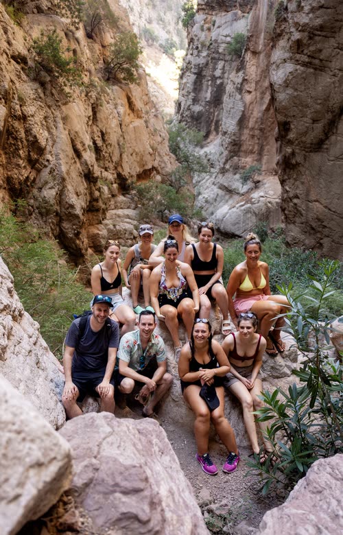 A tour group posed on the boulders inside Saklikent Gorge, Turkey