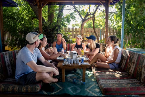 Travellers sitting around a low table on kilim cushions, Turkey