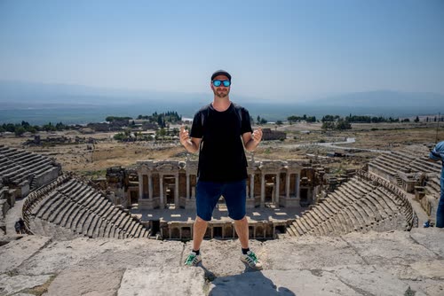A man standing above the tiers of the Roman theatre at Hierapolis, Turkey