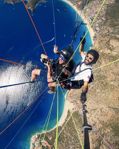 A tandem paraglider pilot and passenger above the Oludeniz lagoon, Turkey