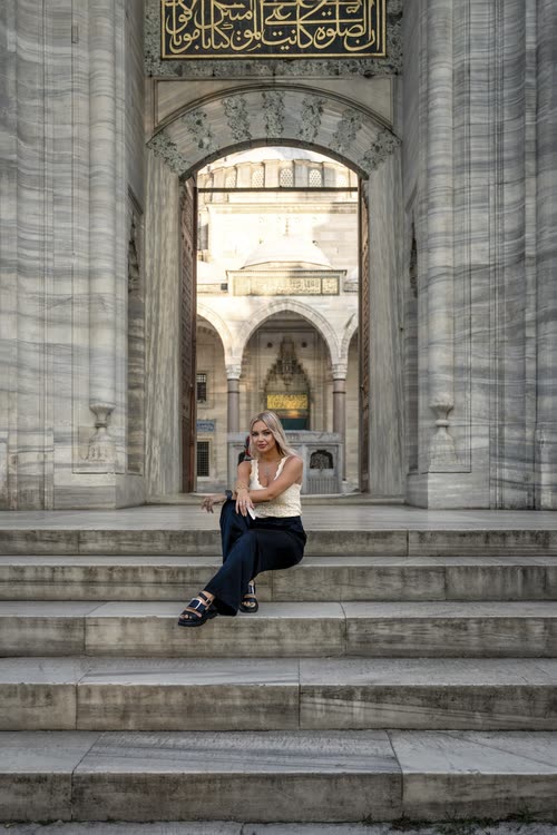 A woman sitting on the steps of the Suleymaniye Mosque gateway, Istanbul