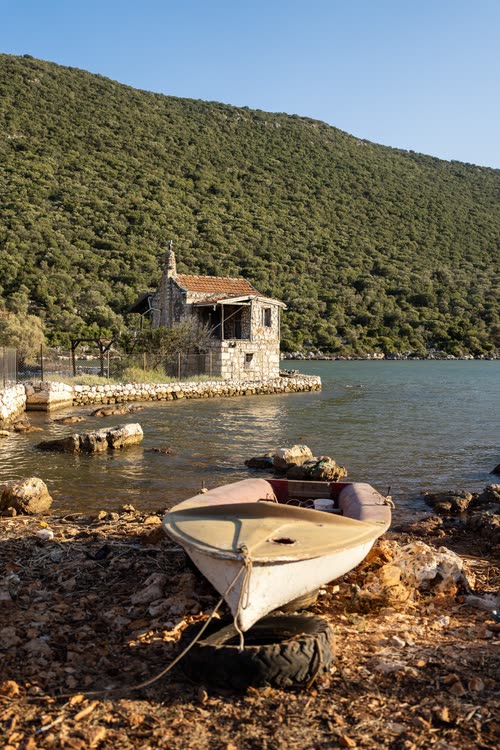 A dinghy pulled up beside a half-submerged ruin on the Kekova shore, Turkey