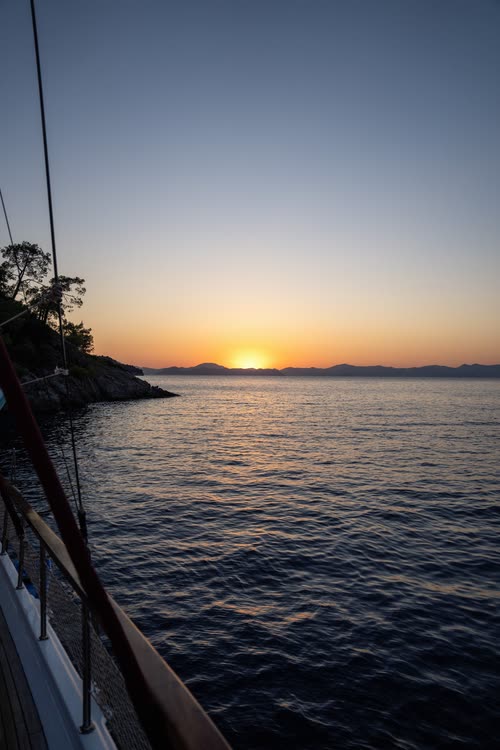The sun setting over the Aegean seen from the deck of a gulet, Turkey