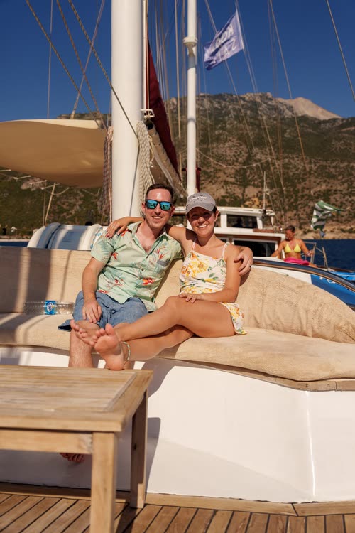 A couple relaxing on the deck cushions of a gulet, Turkey