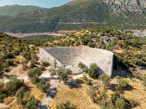 Aerial view of a Roman theatre cut into a hillside above the coast, Turkey