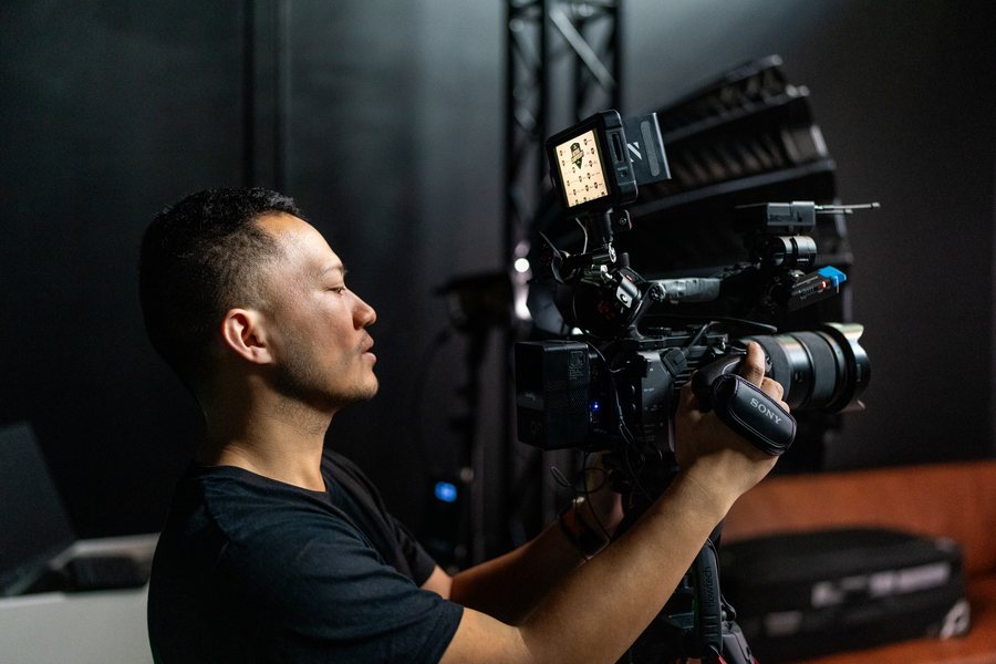 Camera operator framing a shot on a cinema rig during a brand shoot