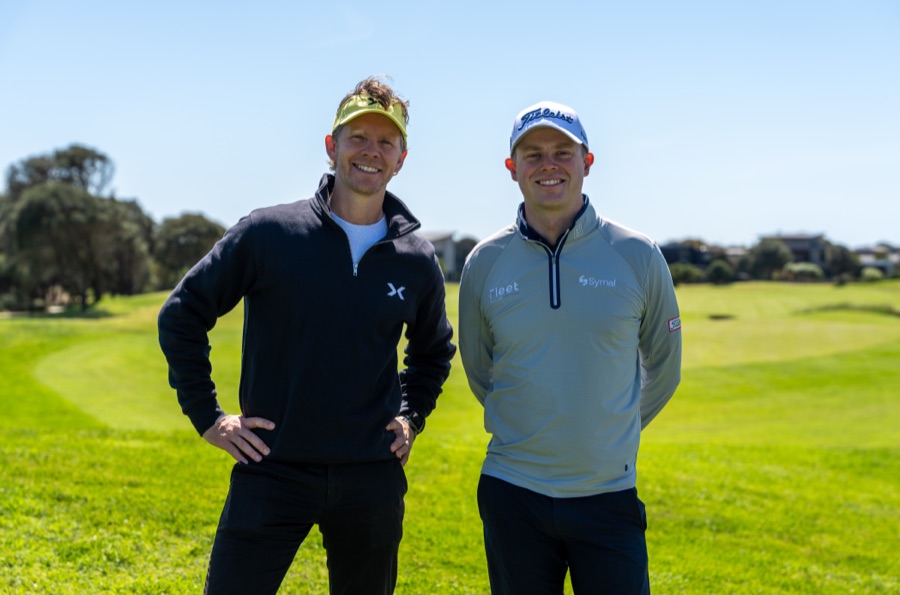 Two golfers photographed on the fairway in branded layers