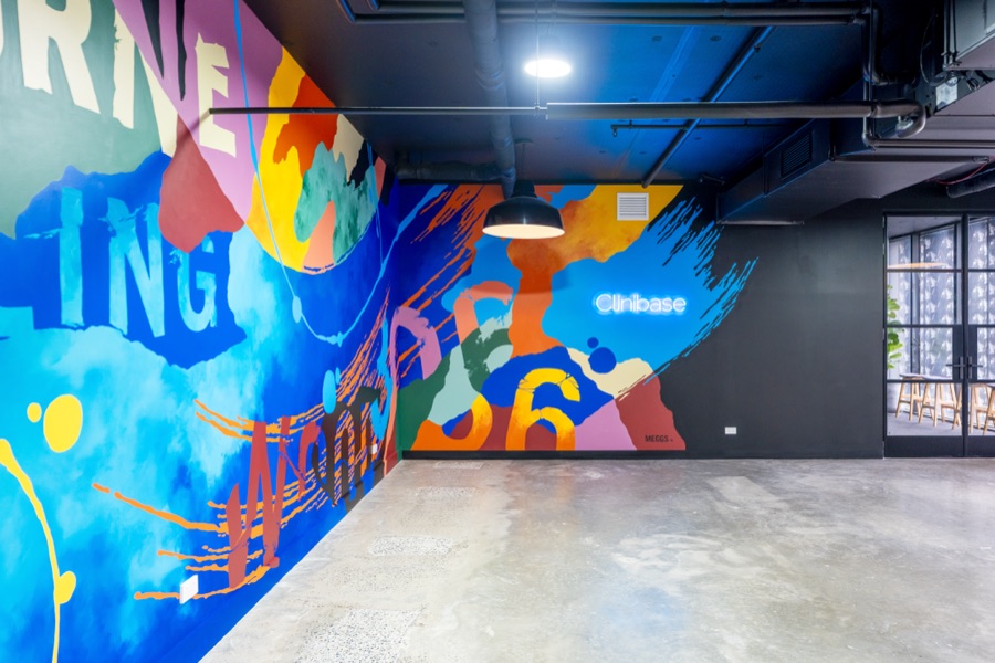 Painted mural wall running the length of a workspace