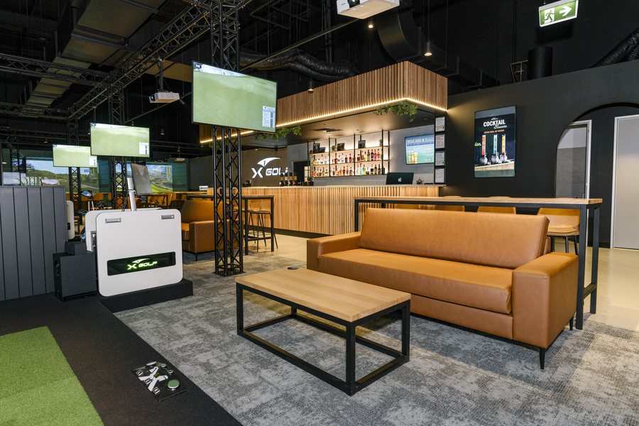 Lounge seating and screens in a finished golf venue fitout