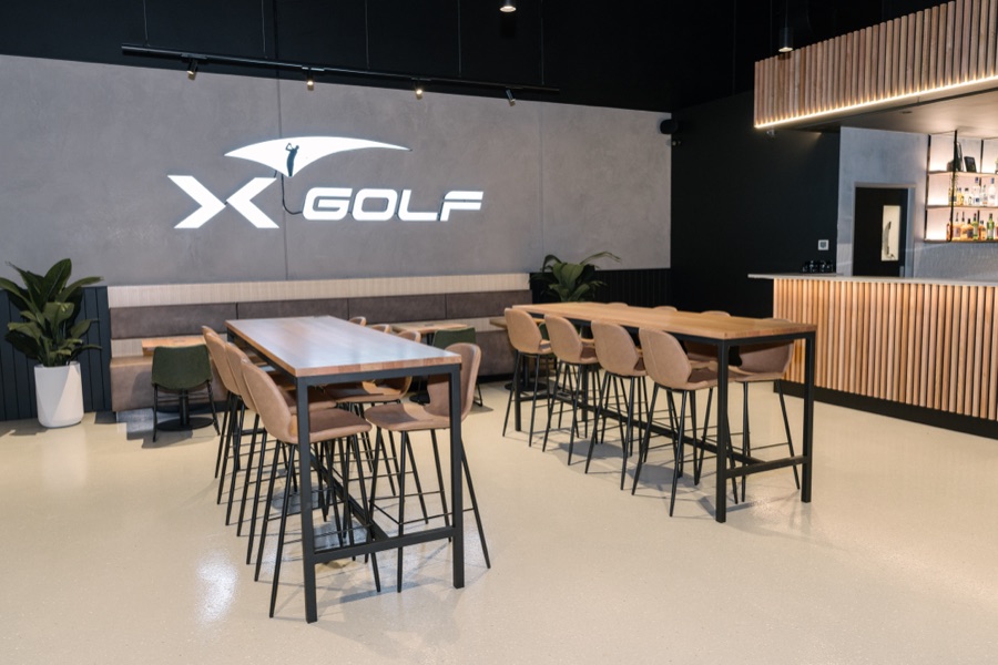 Bar seating and high tables in a finished golf venue