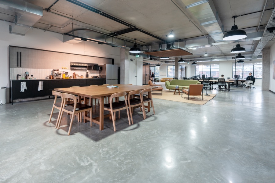 Open plan workspace with long timber tables