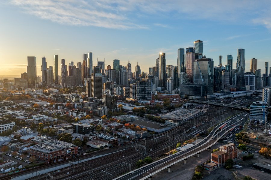 Melbourne CBD towers and rail yards photographed from the air at sunrise