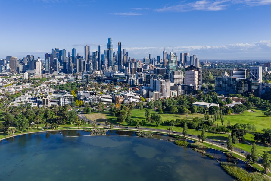 Aerial view across Albert Park Lake to the Melbourne city skyline