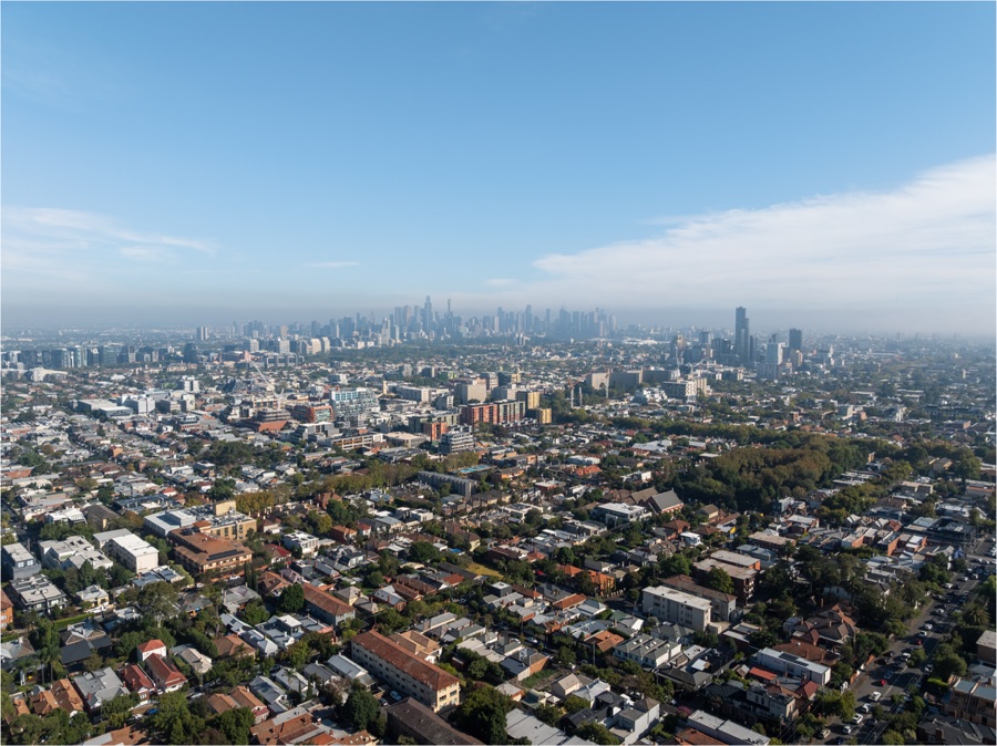 Aerial view across Melbourne's inner suburbs to the CBD skyline