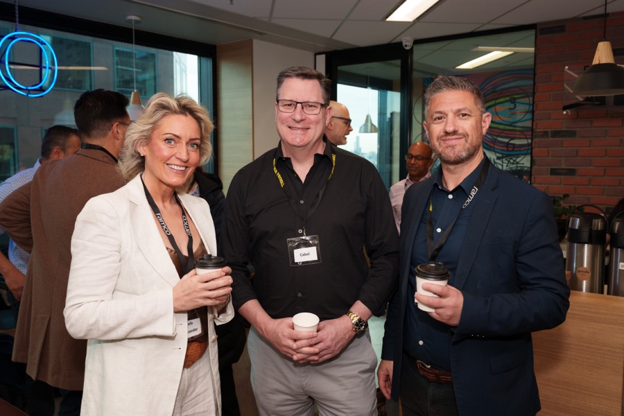 Three guests with drinks at a corporate function