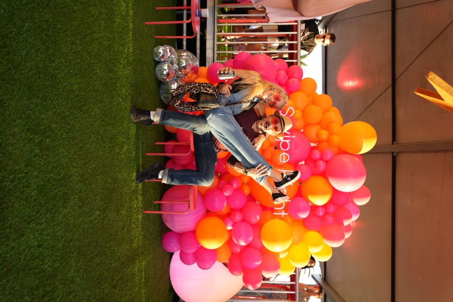Guest posed against a balloon installation at an event