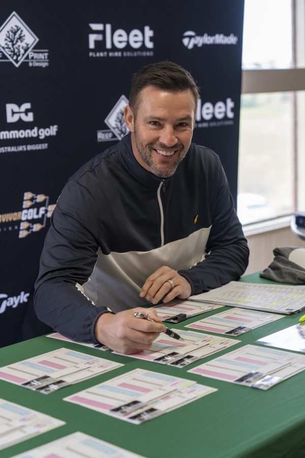 Guest signing in at a branded golf day registration table