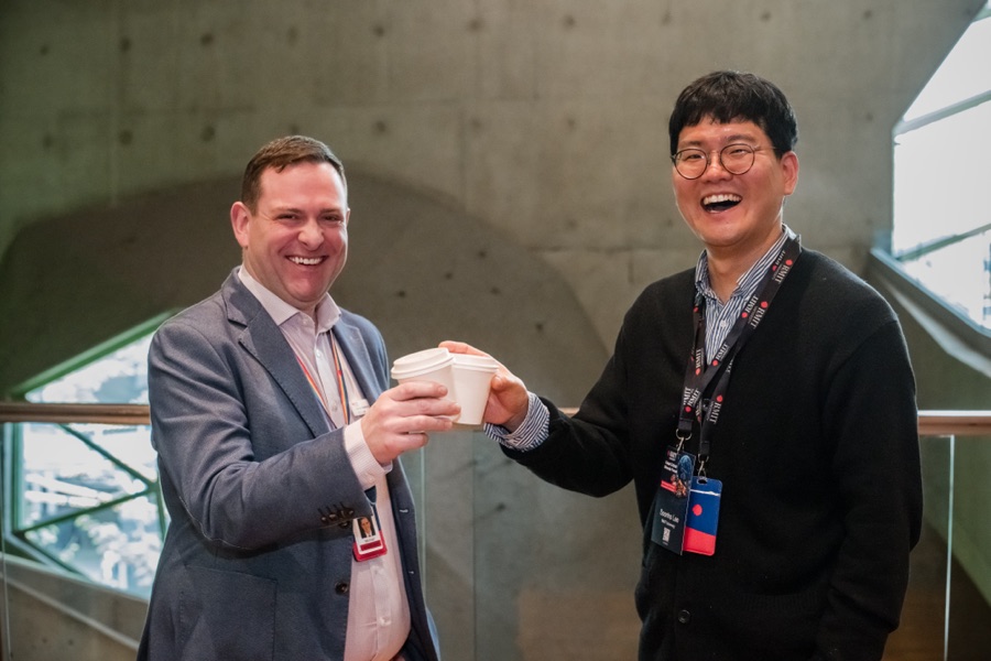 Two delegates raising a toast between sessions