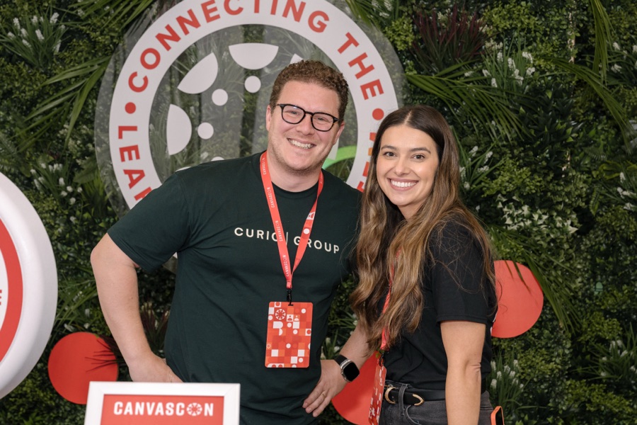 Delegates photographed at the Canvascon branded wall