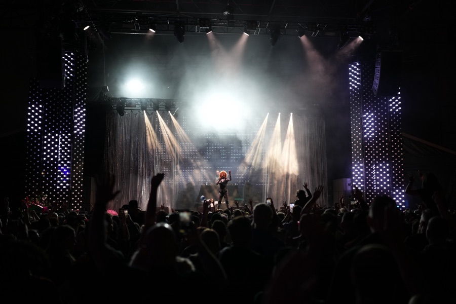 A stage in full light and haze, shot from the back of the room