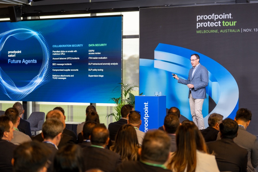 Speaker on the main stage with the audience in frame