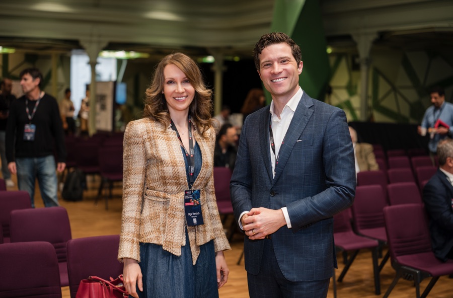 Two delegates photographed together in the auditorium between sessions