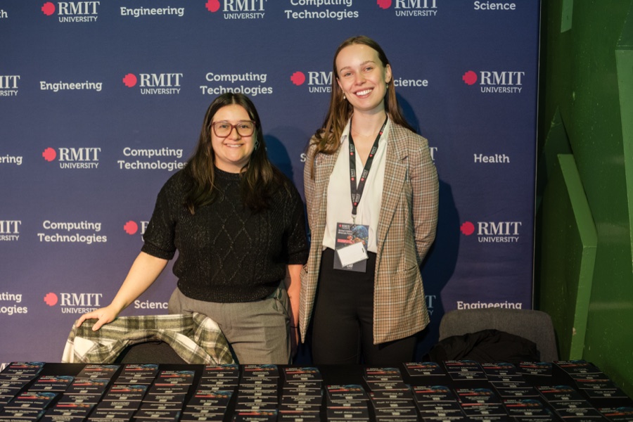 Two delegates at the RMIT media wall