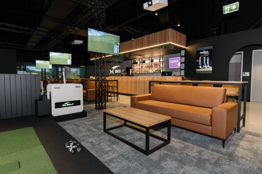 The XGOLF lounge and simulator bays set before play