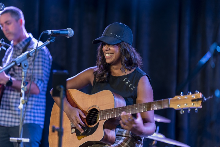 Two musicians performing on a lit stage