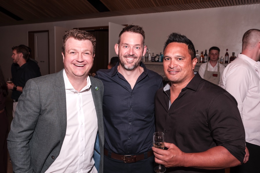 Three guests photographed together at a private event
