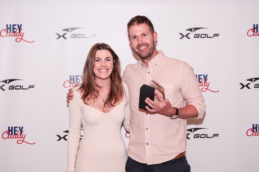 Couple photographed at the sponsor wall