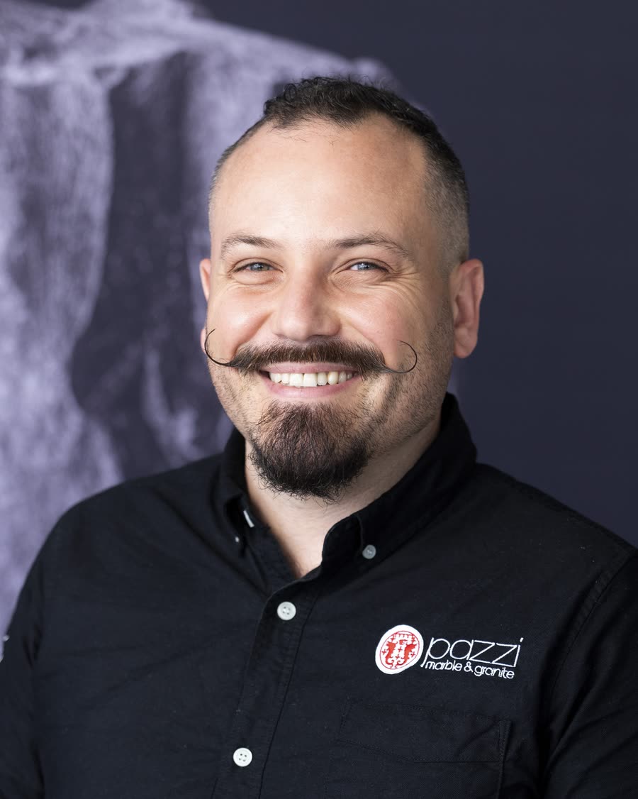 On-location headshot of a stonemasonry team member in a branded shirt