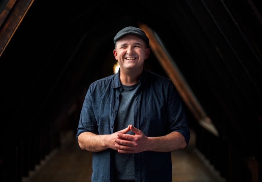 Low light portrait of a man in a cap