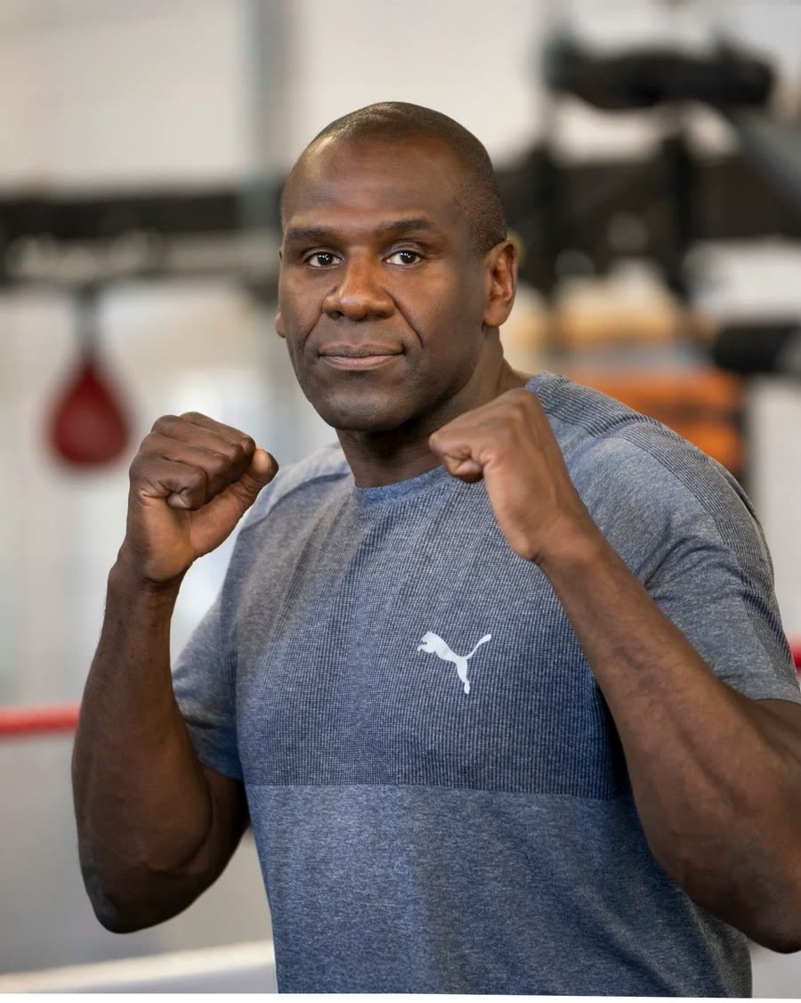 Portrait of a boxing trainer with fists raised in a Melbourne gym