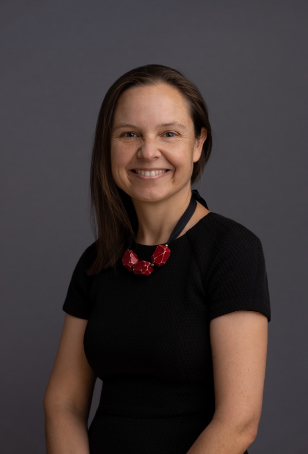 Studio portrait of a woman in black with a red necklace