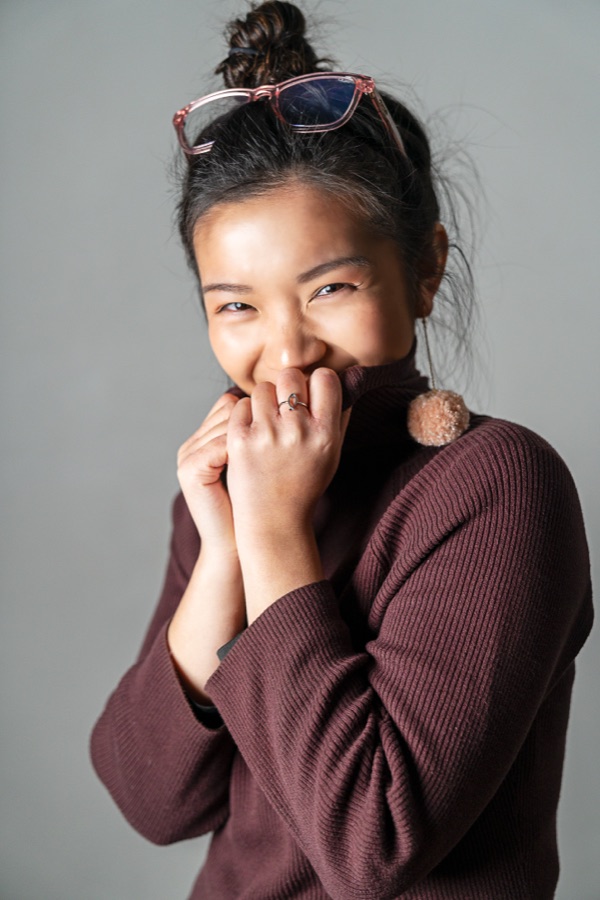 Portrait of a young woman in a maroon knit