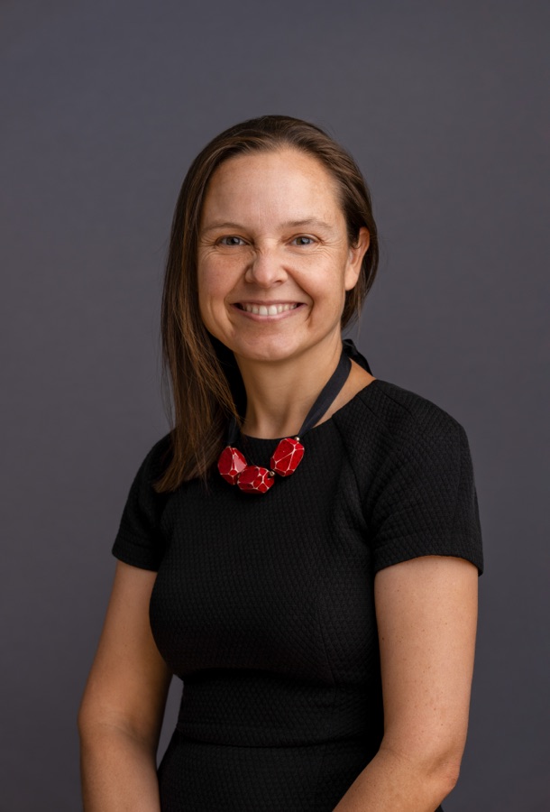 Studio portrait of a woman in black with a red necklace