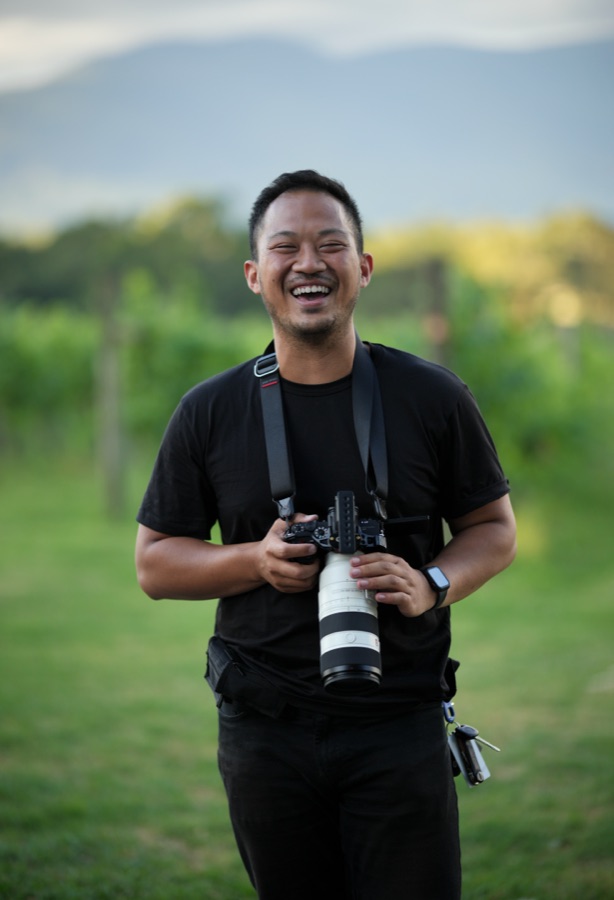 Photographer with his camera on a vineyard row
