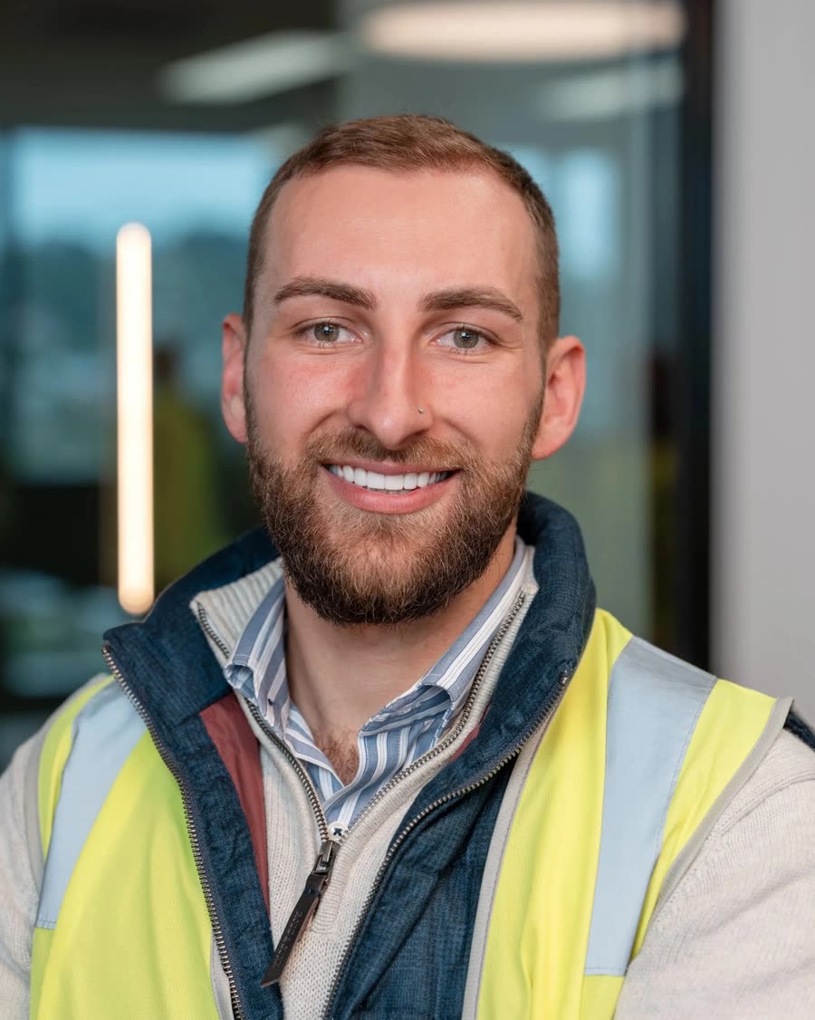 On-location headshot of a construction professional in a hi-vis vest on site