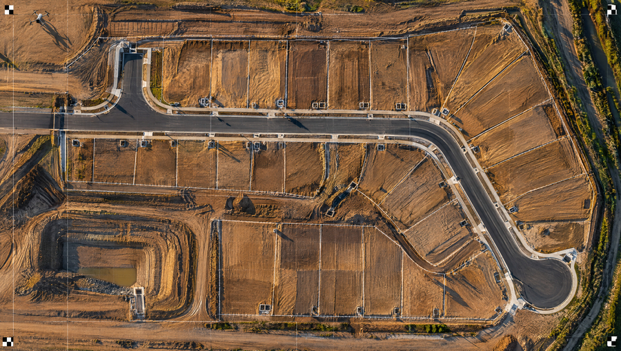 Top down orthomosaic of a Melbourne residential subdivision under construction in low morning light