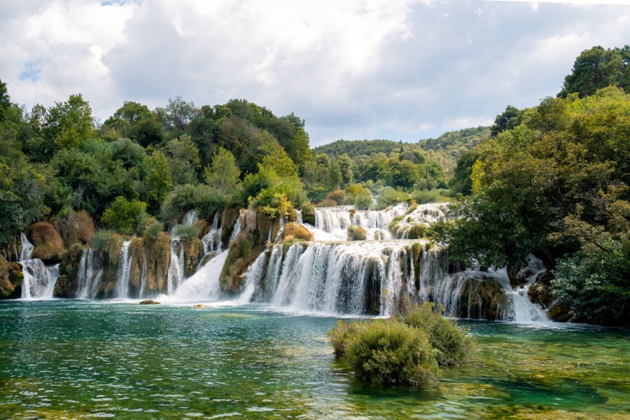 Waterfalls stepping down into green pools