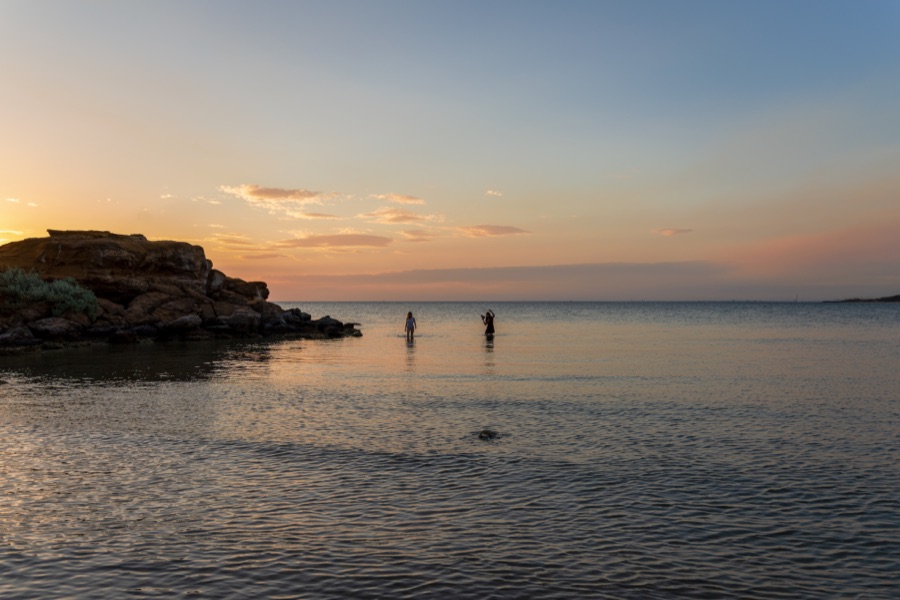Aerial of a rocky islet at sunset