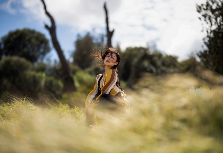 A figure leaping through scrub, shot low through the grass