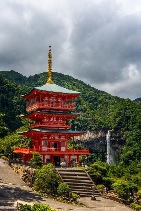 The vermilion three storey pagoda of Seiganto-ji with Nachi Falls behind